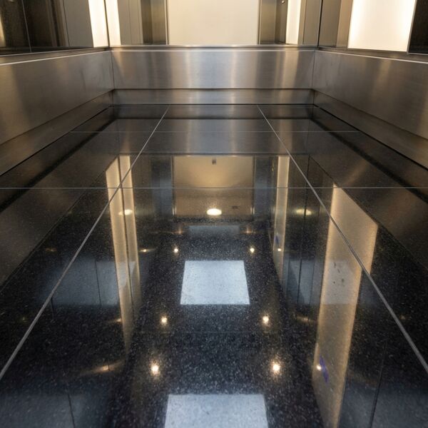 Boutique bronze theme — limestone floor detail with bronze edge trim