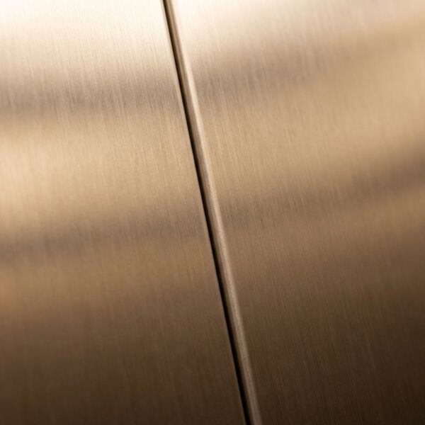 Boutique bronze theme — wall detail showing brushed bronze panel and walnut inlay