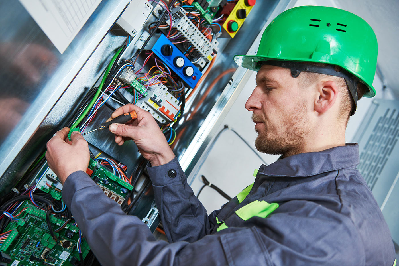 Electrician make maintenance in engine room of elevator